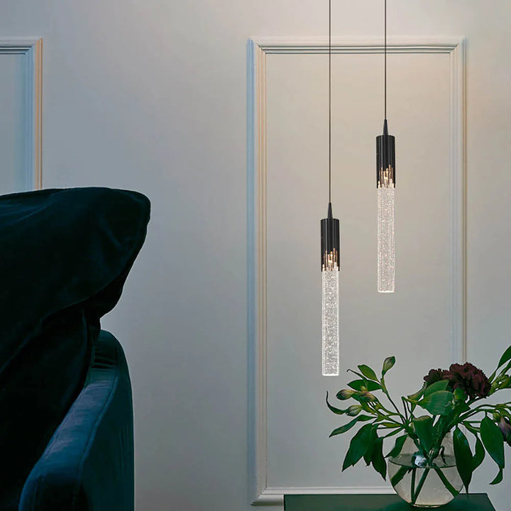 Moderne sylinderformet hengelampe i svart med gull. Minimalistisk stil for stilfull innendørs belysning.