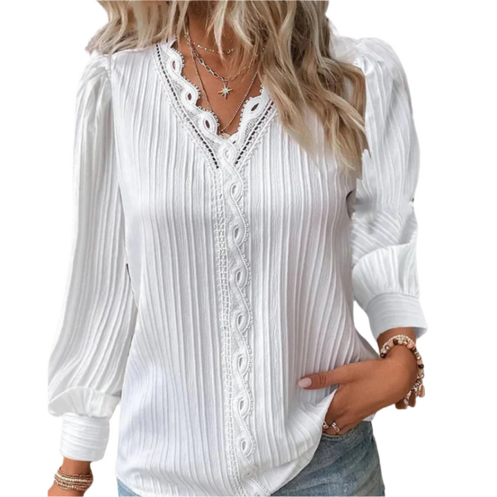 Elegant langermet kvinnebluse med delikate detaljer, perfekt for både hverdags- og festantrekk.