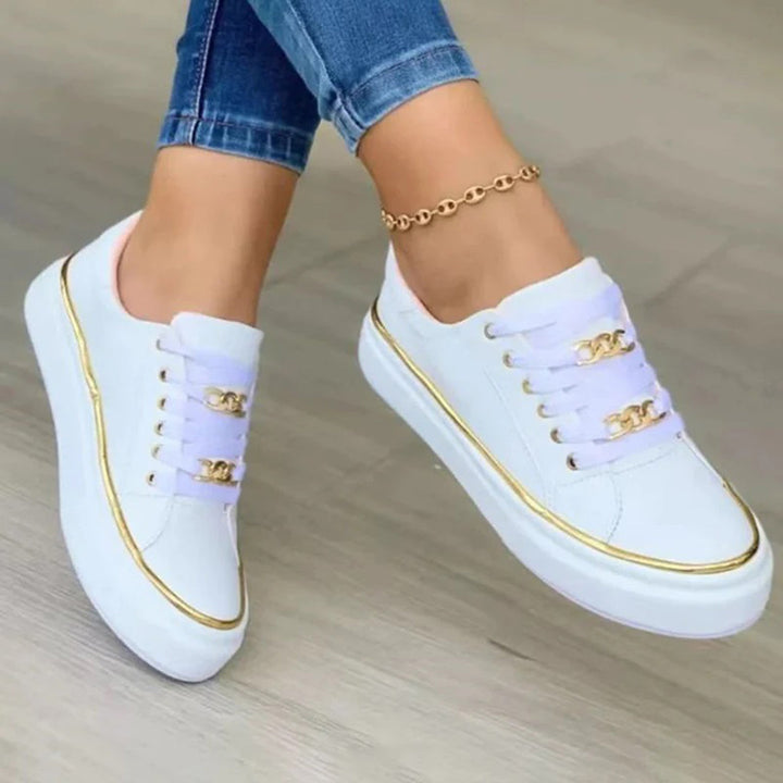 Svarte damesneakers med raffinert design, elegante gull detaljer og optimal komfort. Stilige kvinnersko.