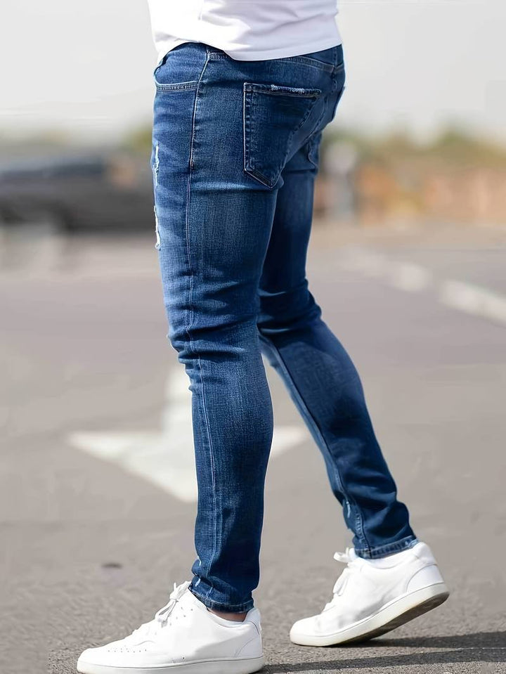 Komfortable, stilige revne jeans for menn med unike detaljer.