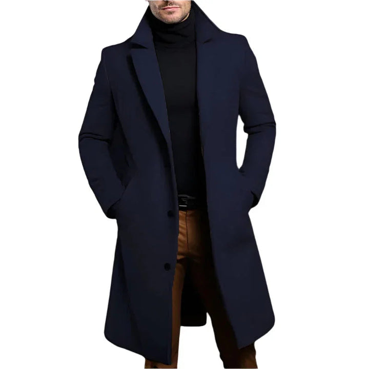 Mann går i bymiljø med sin elegante, skreddersydde ullblanding mellomlang kåpe.