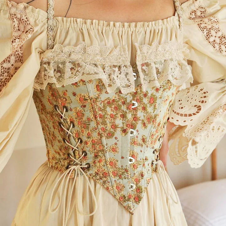 Elegant blomstret korsett-topp for kvinner med justerbar snøring og fine blonder. Feminin mote.
