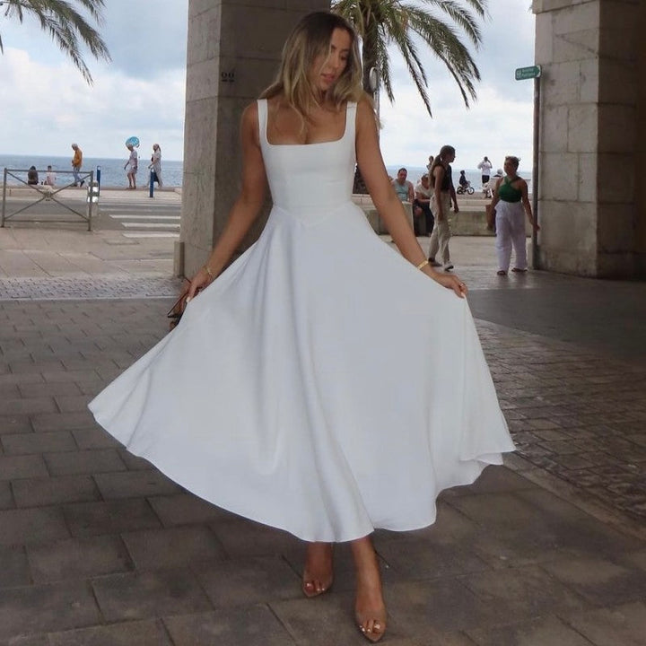 Elegant dame maxikjole med firkantet utringning og svingende skjørt, perfekt for sommer og fest.
