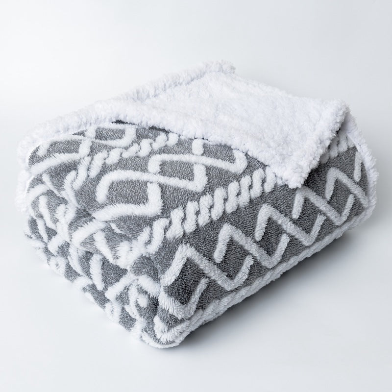 Luksuriøst kosepledd med geometrisk design i myk mikrofiber. Vendbart og varmt damepledd, perfekt for avslapning.