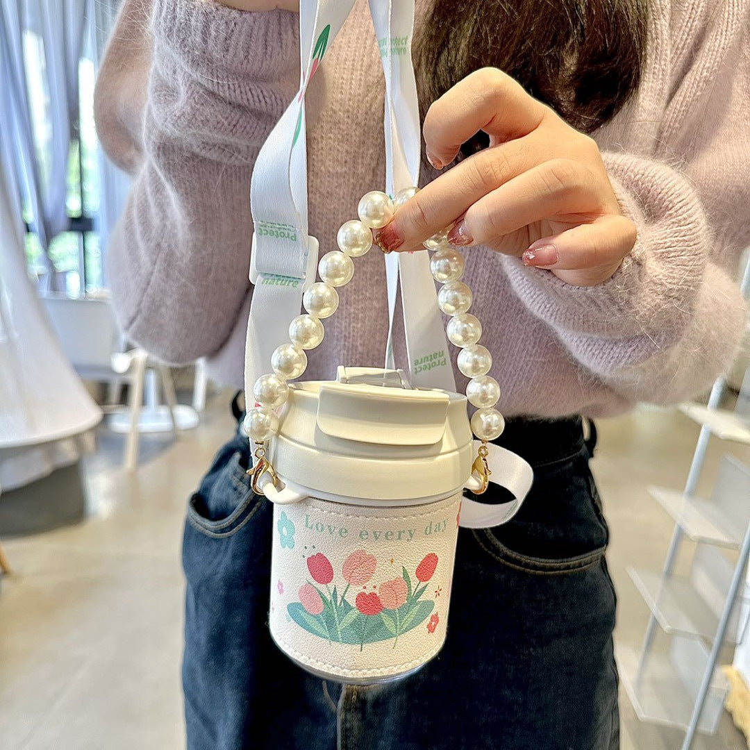 Elegant dame termosflaske med perlehåndtak. Perfekt for kaffe, te eller vann, holder drikken varm/kald lenge.