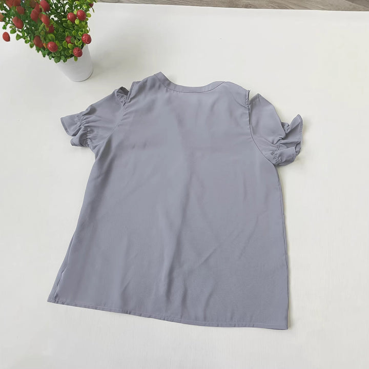 Stilfull grå damebluse med utskårne skuldre, elegant volang og trendy design. Perfekt for fest, kontor eller fritidsbruk.