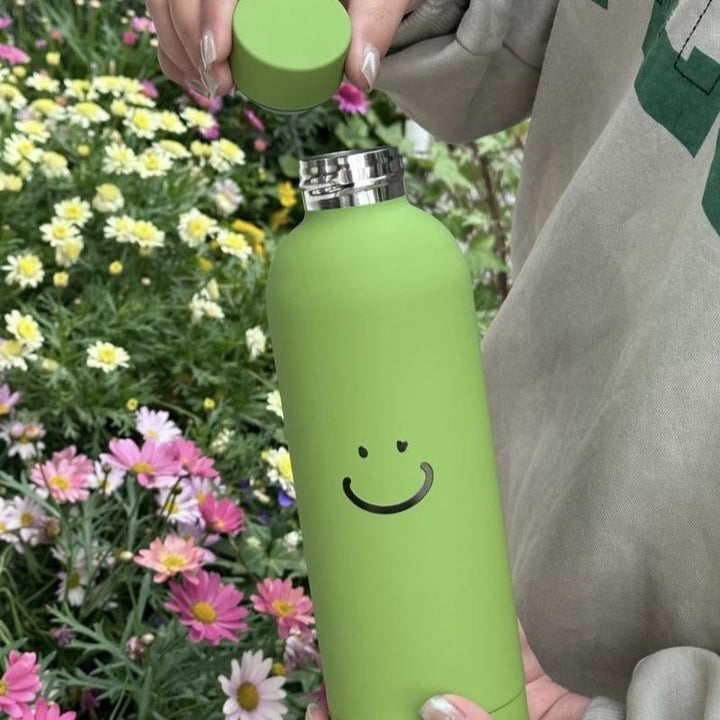 Stilig dame termos i rustfritt stål med smiley-design, lekkasjesikker og perfekt for kontor eller som gave.