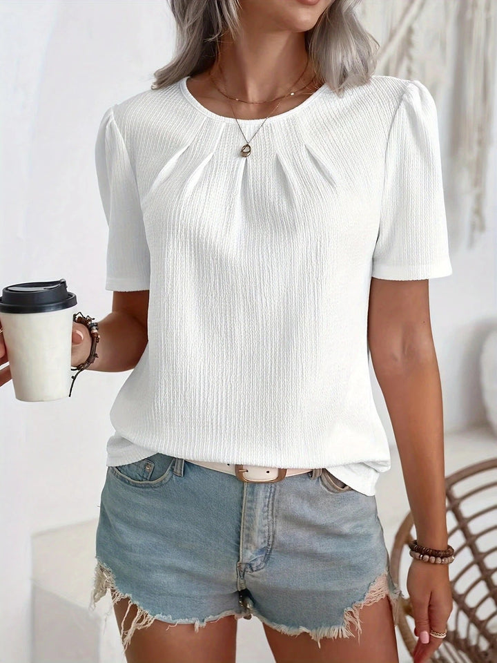 Chic damebluse med strukturert overflate og elegante puffermer for en sofistikert look.