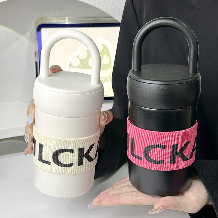 Dame termokopp for reise, med lekkasjesikker design og komfortabelt bærehåndtak.