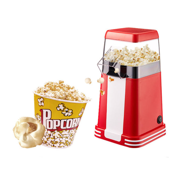 Klassisk rød retro popcornmaskin i bruk. Ideell for ferske snacks, filmkveld og familiesamlinger.