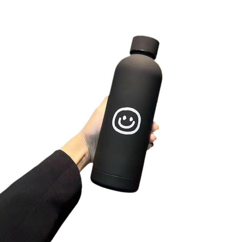 Dame termosflaske 500ml med gledelig smilmotiv, en perfekt gaveide som holder drikken temperert.