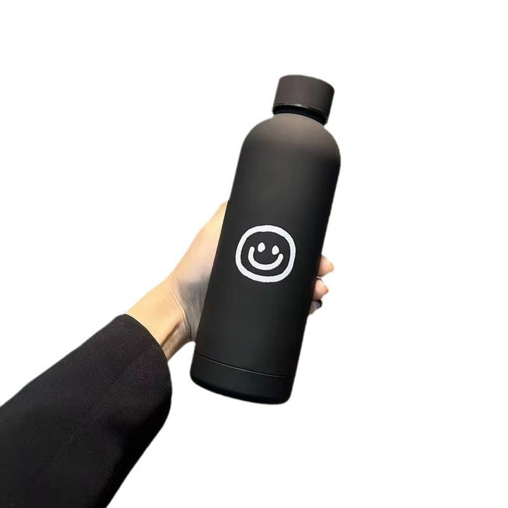 Dame termosflaske 500ml med gledelig smilmotiv, en perfekt gaveide som holder drikken temperert.