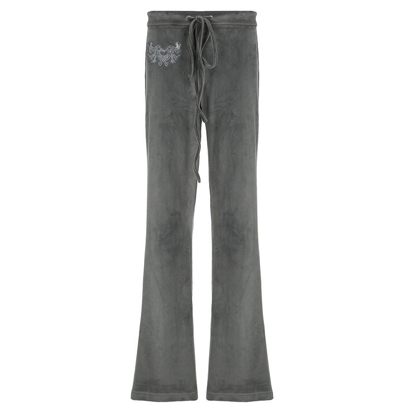 Ryggvisning av grå dame flared sweatpants, som viser den vide passformen og komfortable silhuetten.