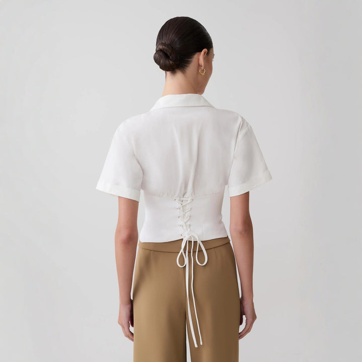 Elegant kortermet hvit V-hals bluse for kvinner. En stilren damebluse, ideell for casual sommerbruk.