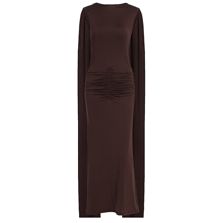 Brun elegant maxikjole med rynker og gjennomsiktige ermer. Flott til fest og spesielle anledninger.