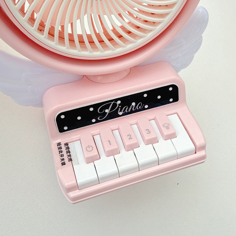 Bærbar bordvifte i pianodesign, rosa. Kompakt USB-vifte for kjøling på hjemmekontor eller sommerbruk.