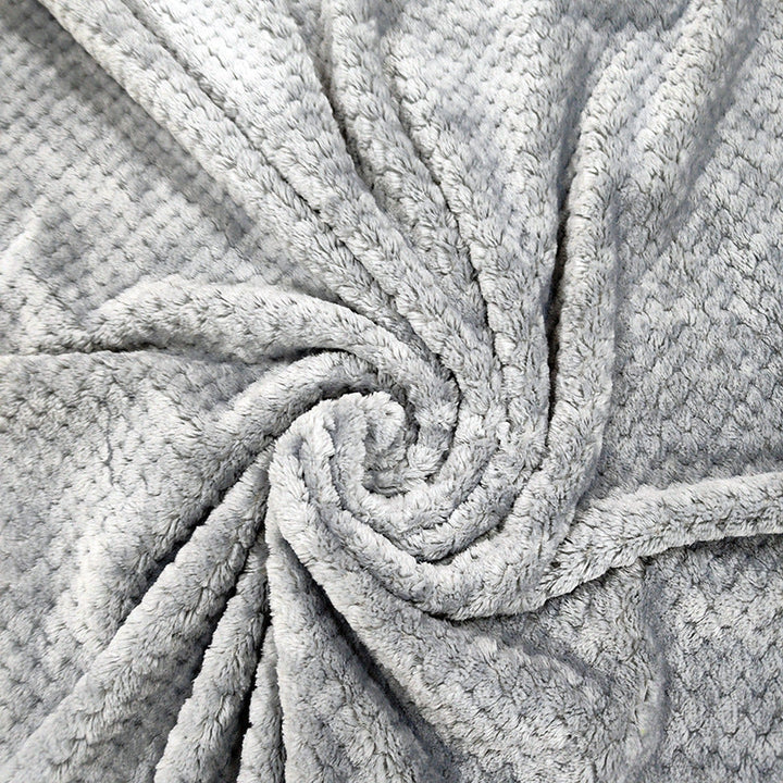 Dame koseteppe med vaffelstruktur i mikrofiber. Perfekt pledd for kalde kvelder, gir god varme.
