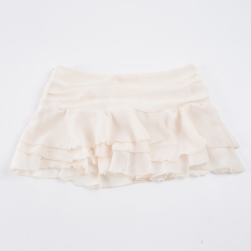 Allsidig dameskjørt med volanger og elastisk midje. Tilgjengelig i rød og hvit, for en elegant sommerstil.