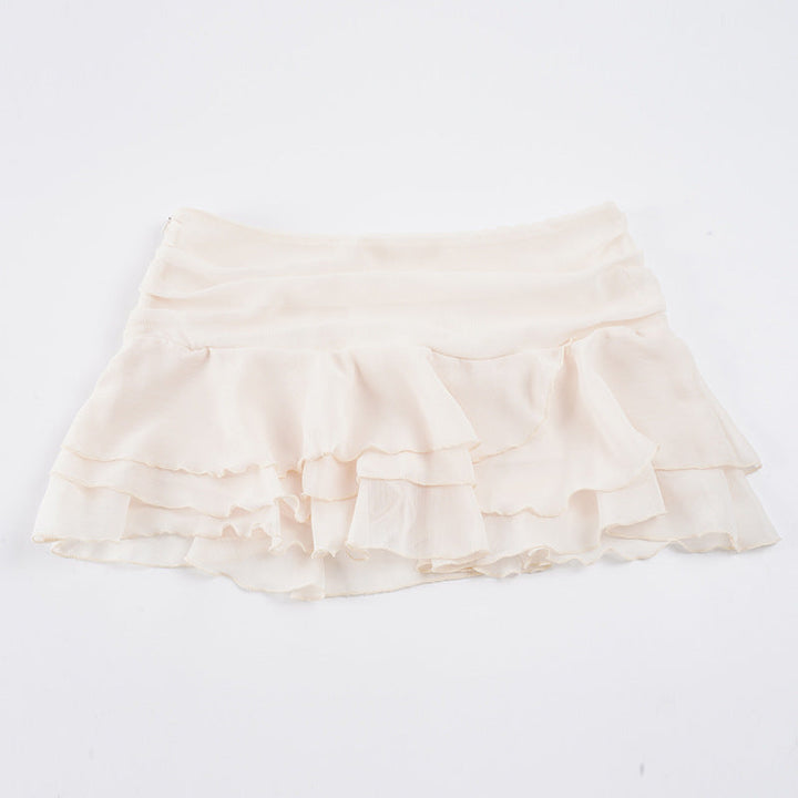 Allsidig dameskjørt med volanger og elastisk midje. Tilgjengelig i rød og hvit, for en elegant sommerstil.
