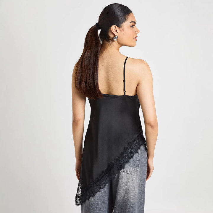 Hvit spiss cami for dame, asymmetrisk snitt. Trendy og feminin sommertopp i mote.