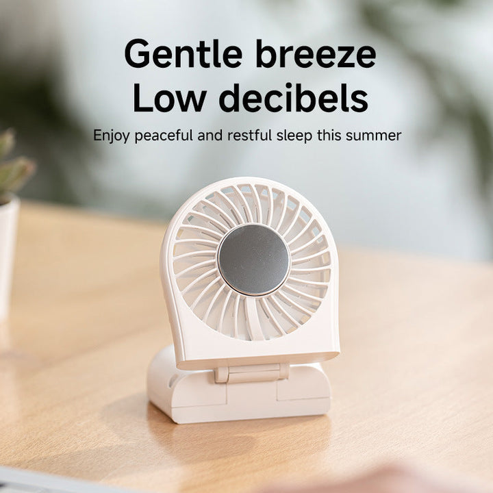 Stilren minivifte for dame med kompakt design og kraftig luftstrøm. Essensiell gadget for varme dager.