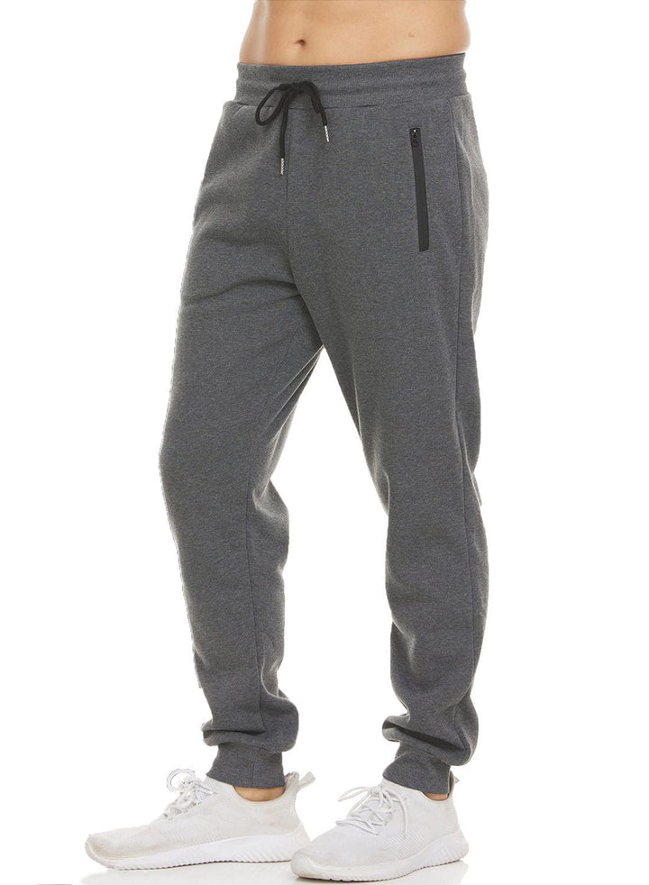 Allsidig herre sportsklær: mørkegrå joggebukse med sikre glidelåslommer for trening og casual bruk.