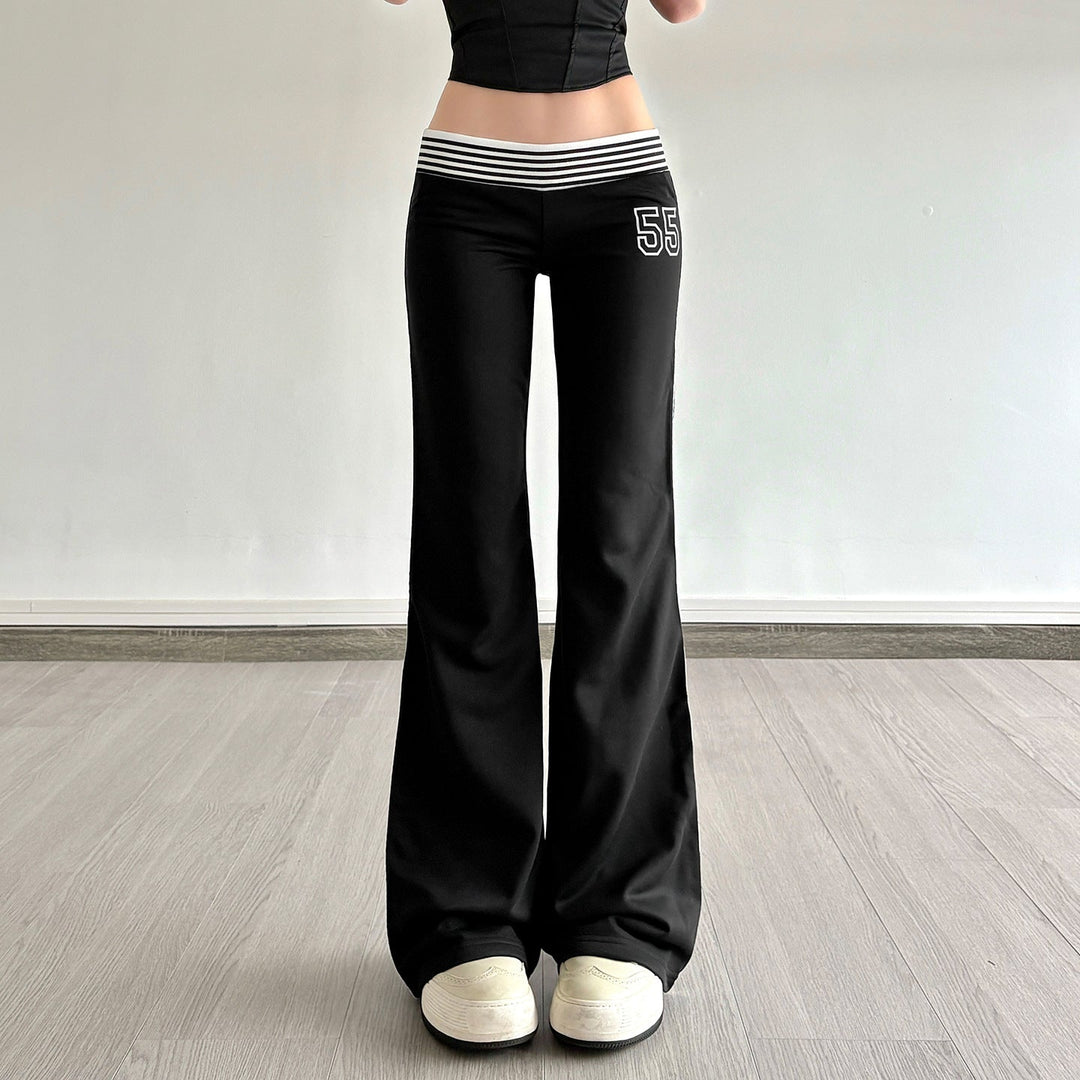 Svarte flared joggebukser for dame med hvite sidestriper. Komfortabel og trendy fritidsbukse med elastisk midje.