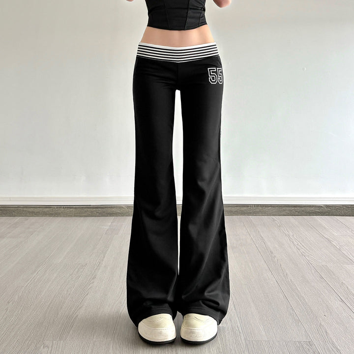 Svarte flared joggebukser for dame med hvite sidestriper. Komfortabel og trendy fritidsbukse med elastisk midje.