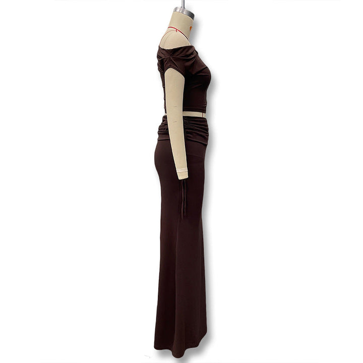 Stilig langermet brun maxikjole for dame, med unikt asymmetrisk design, ideell som elegant aftenkjole.