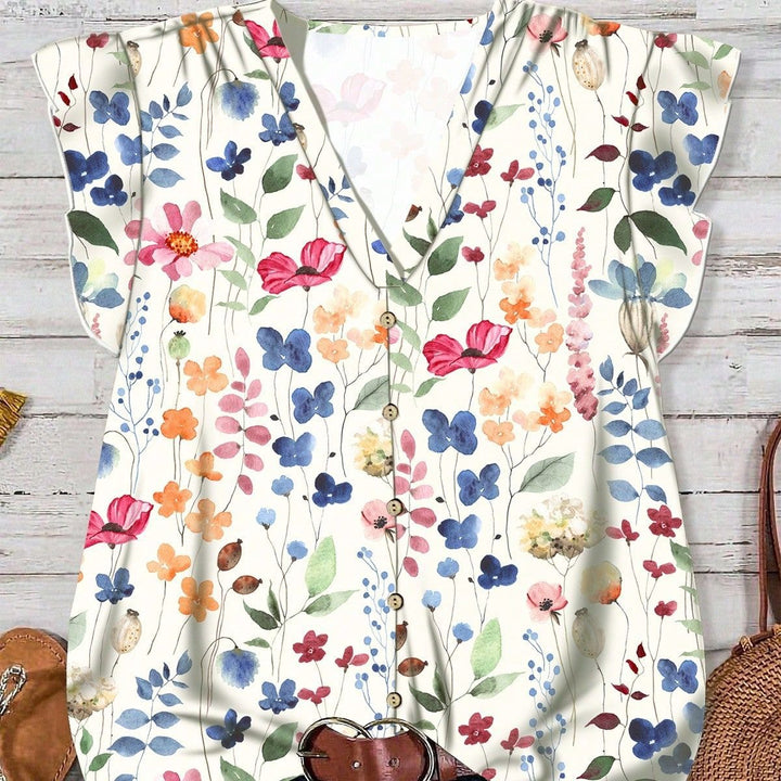 Vår-/sommerbluse i lett stoff med nydelig blomsterdesign og stilig V-hals for damer.