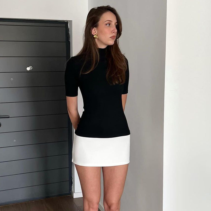Stilfull dame topp med kortermet design og elegant rullekrage, perfekt for vår og sommer.
