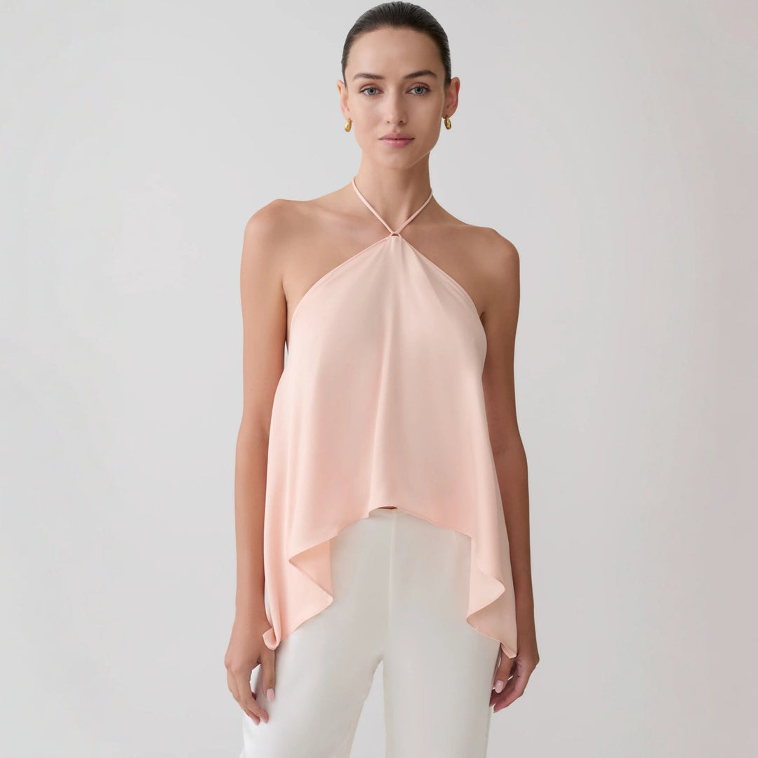 Vakker rosa dame topp med halterneck og asymmetrisk design. Allsidig festtopp for sommeren.