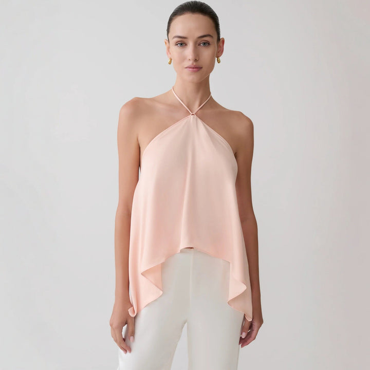 Vakker rosa dame topp med halterneck og asymmetrisk design. Allsidig festtopp for sommeren.