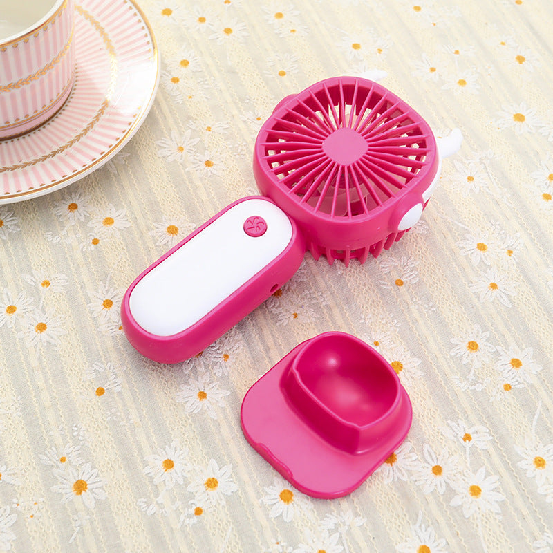 Stilren gul og magenta USB-minivifte, bærbar for enkel kjøling om sommeren. Ideell personlig gadget.