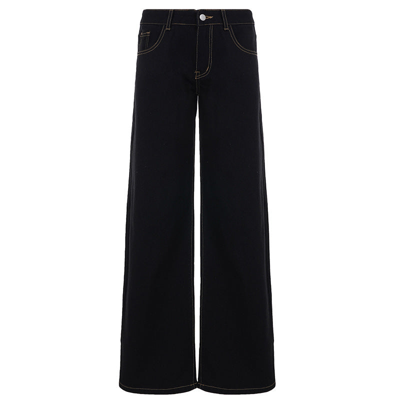 Detaljbilde av svarte vide damejeans med høy midje, viser stoff og passform.