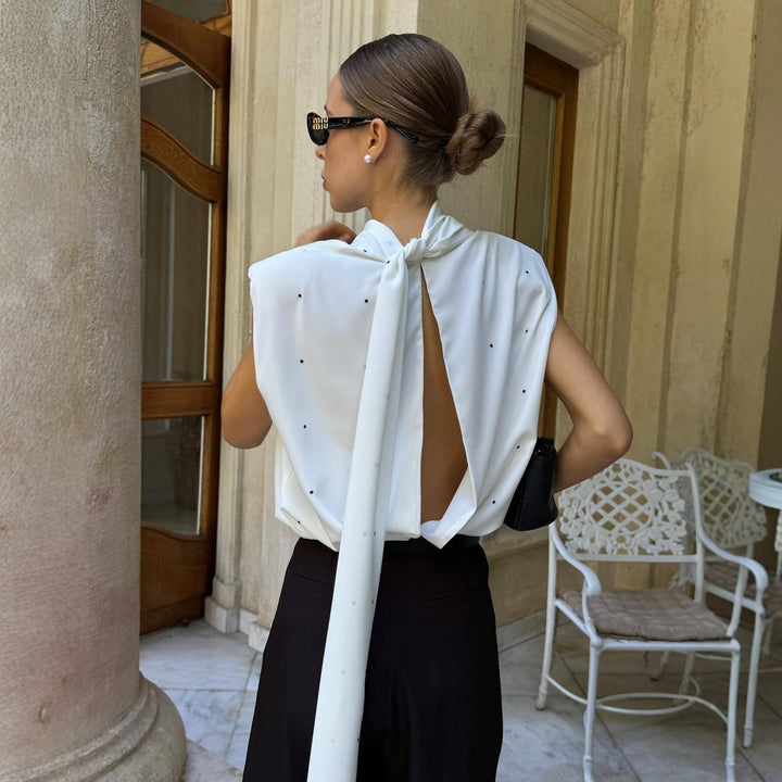 Stilfull hvit dame langermet topp med høy krage og prikker, perfekt for elegant kontorstil eller fest.