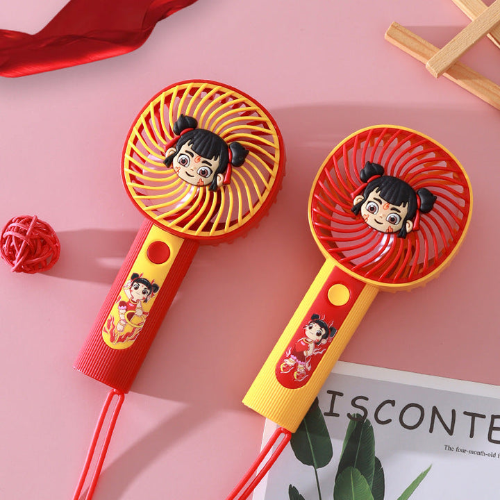 Morsom tegneserie mini-håndvifte, oppladbar og bærbar, gir frisk luft med et søtt design. Gul farge.