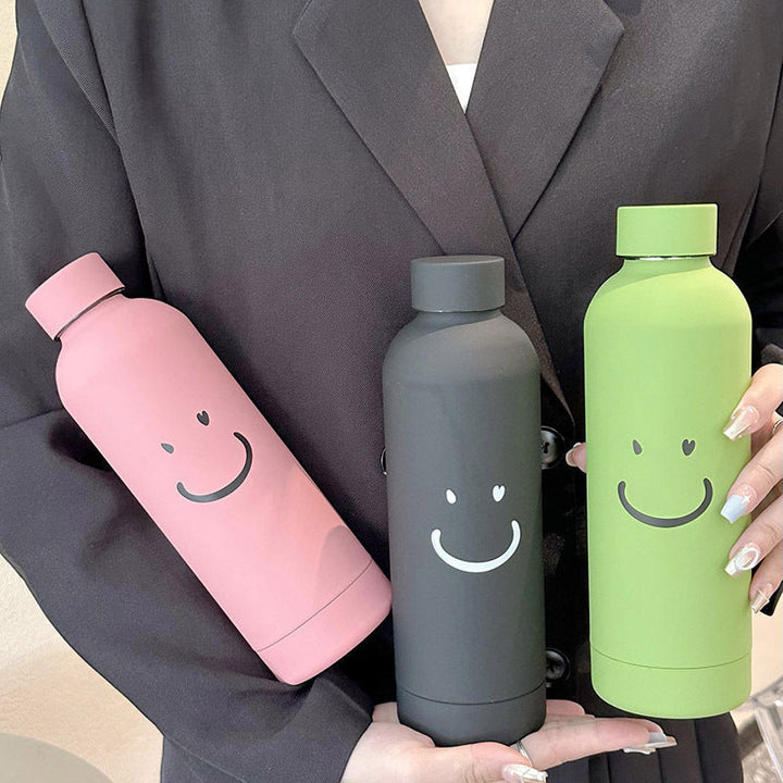 Gaveidé: 500ml termoflaske for kvinner med gult smilmotiv. Bærbar, rød isolert drikkeflaske.