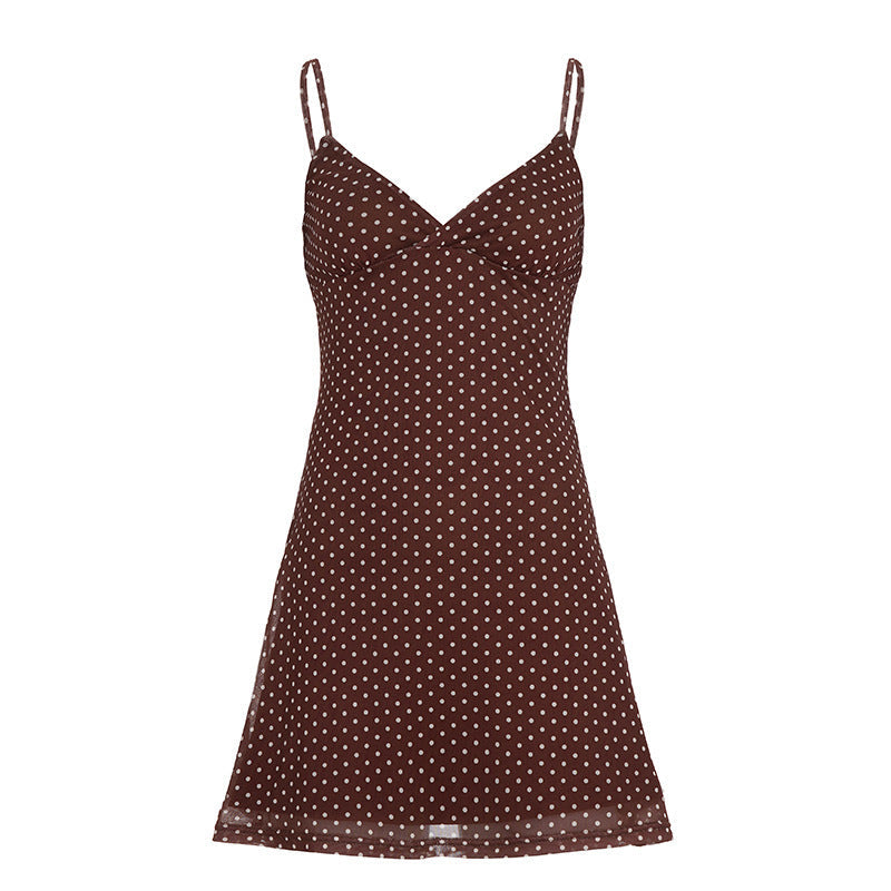 Motebevisst dame topp med klassiske polka dots og spaghetti-stropper. Elegant casual stil med lett fall for kvinner.