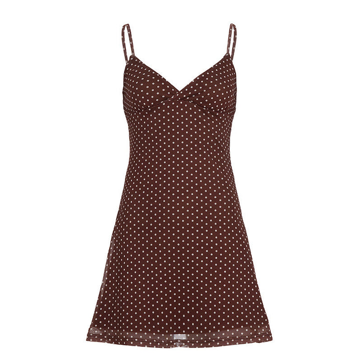 Motebevisst dame topp med klassiske polka dots og spaghetti-stropper. Elegant casual stil med lett fall for kvinner.