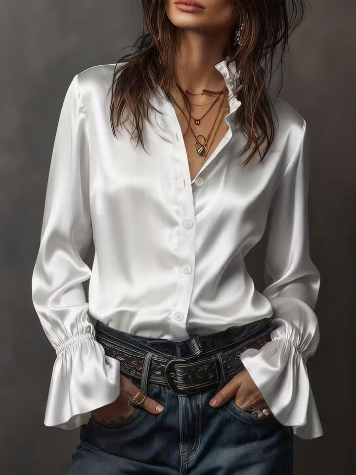Delikat damebluse med sofistikerte rysjer på ermene, ideell for en elegant og feminin vårlook. Festbluse.