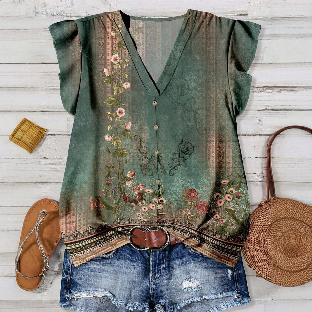 Elegant damebluse med blomsterprint og V-hals, perfekt for vår og sommerbruk.