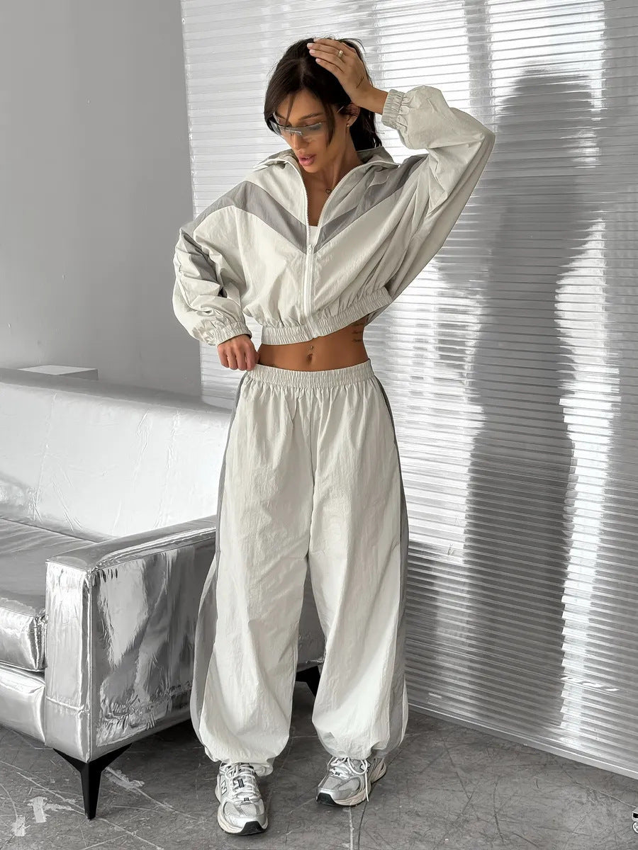 Stilfull dametreningsdress i fargekoordinert design. Komfortabelt matchende sett med jakke og bukser for fritid.