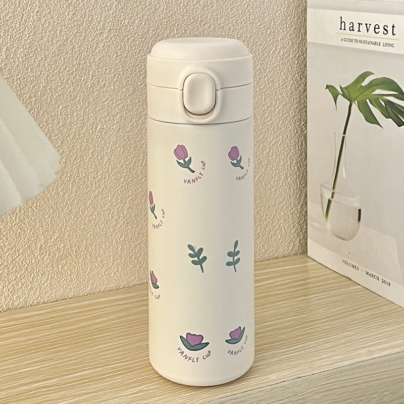 Dame isolerende drikkeflaske i grønt rustfritt stål med vakkert blomsterdesign. Holder drikken frisk.