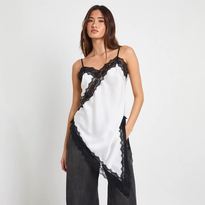 Elegant asymmetrisk spiss cami for dame, perfekt for fest eller sommer. Stilig og feminin topp.