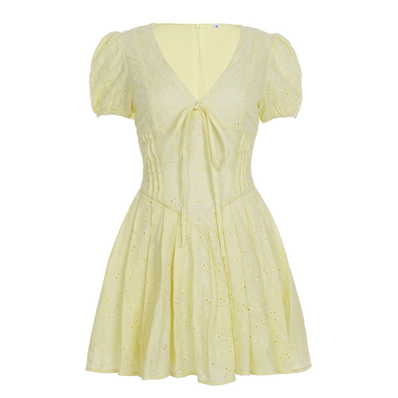Hvit elegant festkjole med V-hals og korte ermer. Har rysjer og bånd, en flott sommerstil.
