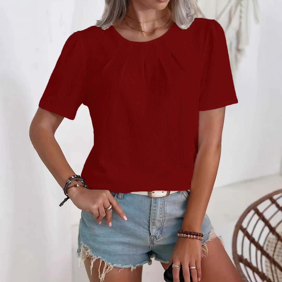 Klassisk damebluse med moderne puffermer og subtilt strukturert design, for hverdag og fest.
