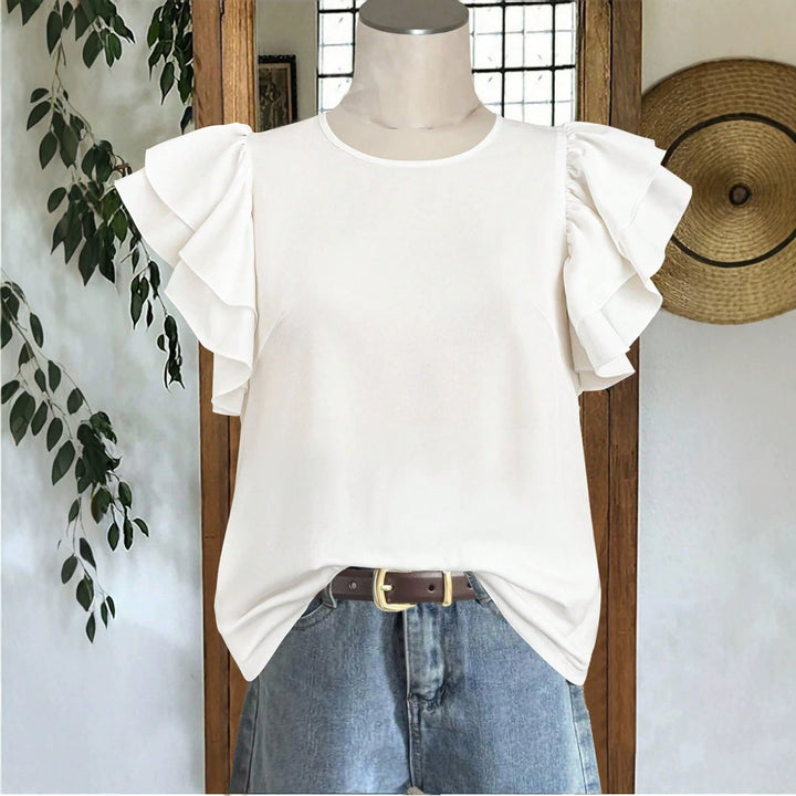 Komfortabel blå damebluse med volanger. Løs passform og elegant stil for hverdag og kontor.