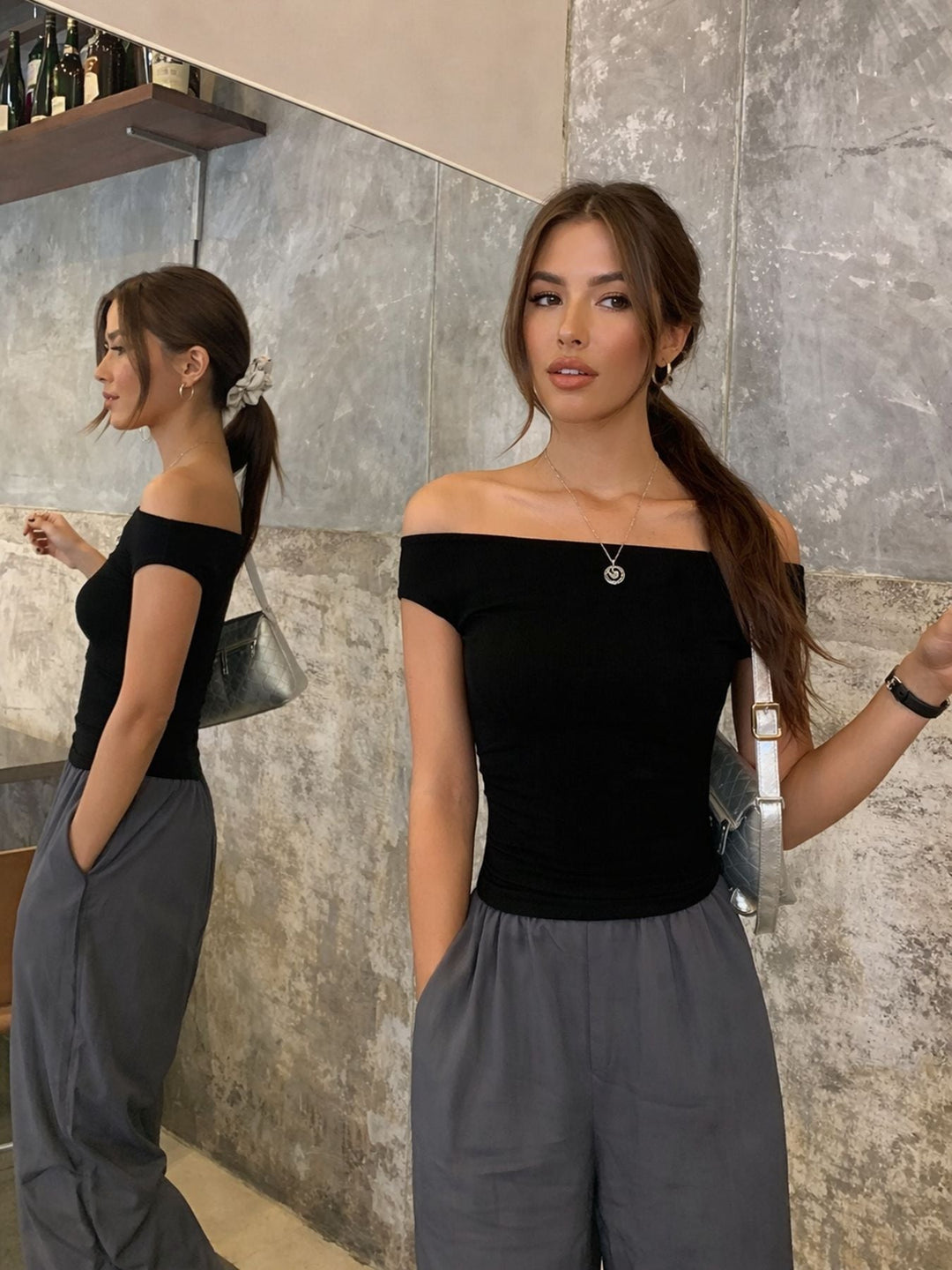 Stilren svart off-shoulder dametopp med moderne snitt, en elegant overdel for enhver sommeranledning.