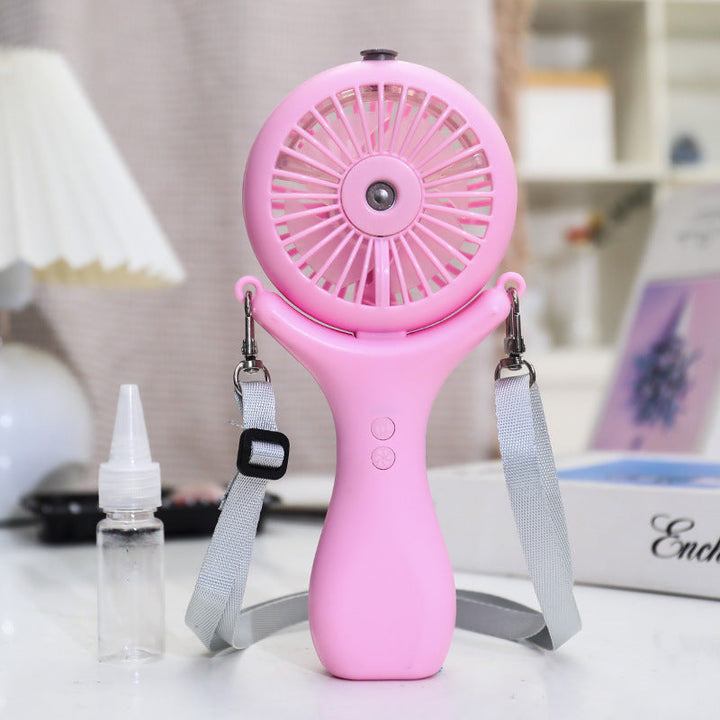 Liten og praktisk rosa minivifte med spray for bærbar kjøling, et must for sommerens utflukter.